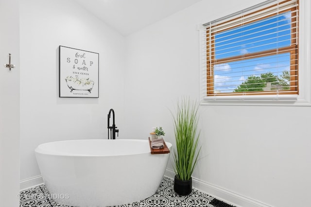 384 Edgewater Ct, Sugar Grove, IL 60554 - full bathroom with baseboards, a freestanding tub, tile patterned floors, and lofted ceiling