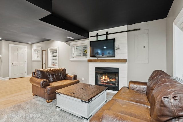 384 Edgewater Ct, Sugar Grove, IL 60554 - living area featuring electric panel, a large fireplace, wood finished floors, and baseboards