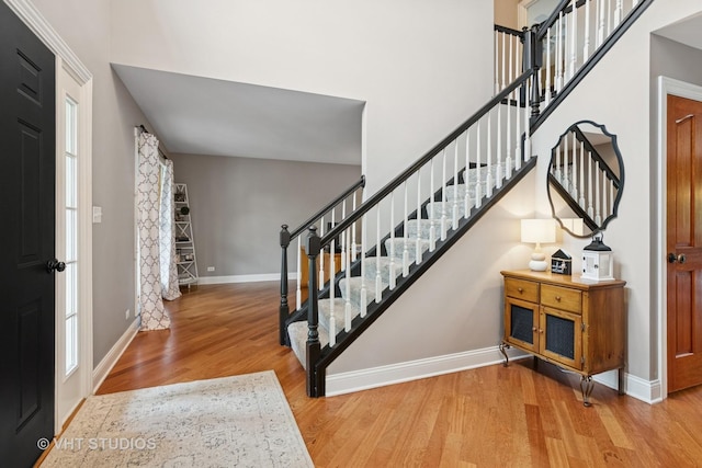 384 Edgewater Ct, Sugar Grove, IL 60554 - entryway with wood finished floors, stairway, baseboards, and a high ceiling