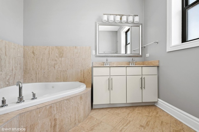 bathroom featuring double vanity, a garden tub, and baseboards