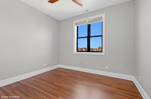 unfurnished room with baseboards, a ceiling fan, and wood finished floors