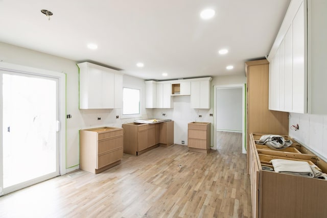 kitchen with light wood finished floors, recessed lighting, and white cabinetry
