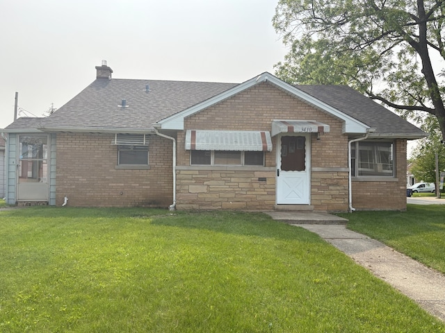 3410 Calwagner St, Franklin Park, IL 60131 - view of front of home with a chimney, a shingled roof, a front lawn, and brick siding