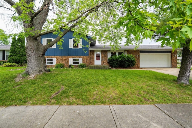 tri-level home with brick siding, a garage, a front lawn, and concrete driveway