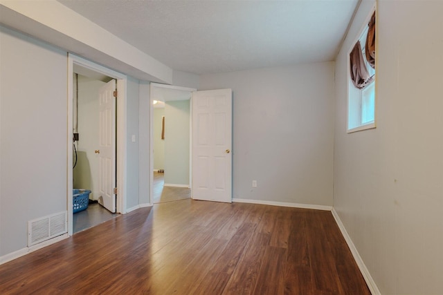unfurnished bedroom featuring wood finished floors and baseboards