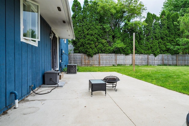 view of patio / terrace with an outdoor fire pit and central air condition unit