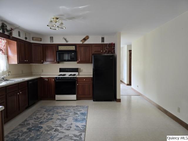 722 Wabash Ave, Carthage, IL 62321 - kitchen featuring black appliances, a sink, and light countertops