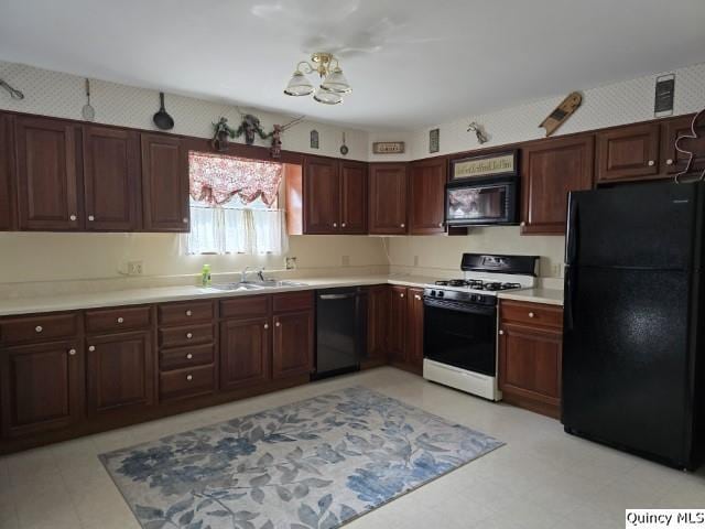 722 Wabash Ave, Carthage, IL 62321 - kitchen with black appliances, light flooring, light countertops, and a sink