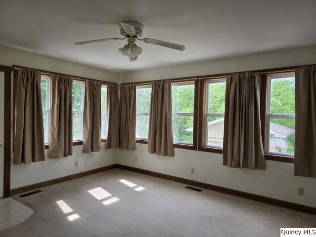 722 Wabash Ave, Carthage, IL 62321 - empty room with carpet, baseboards, and a ceiling fan