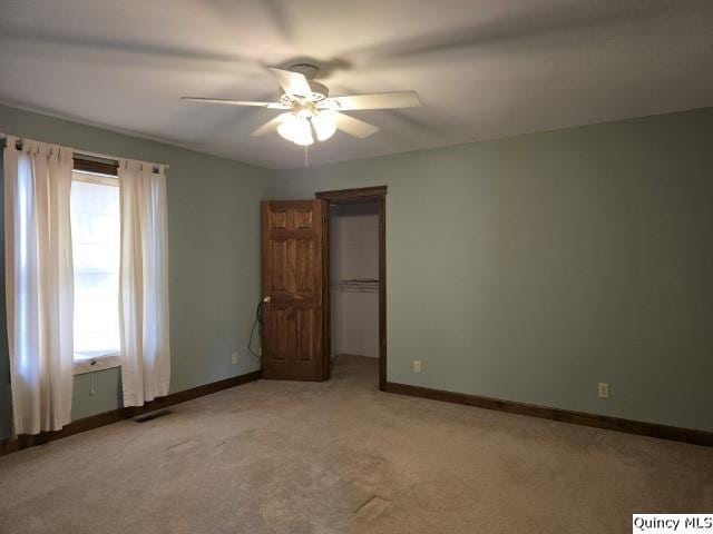 722 Wabash Ave, Carthage, IL 62321 - unfurnished bedroom featuring light carpet, baseboards, a closet, and a ceiling fan