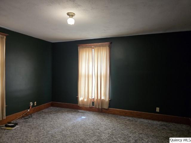 722 Wabash Ave, Carthage, IL 62321 - carpeted empty room with baseboards