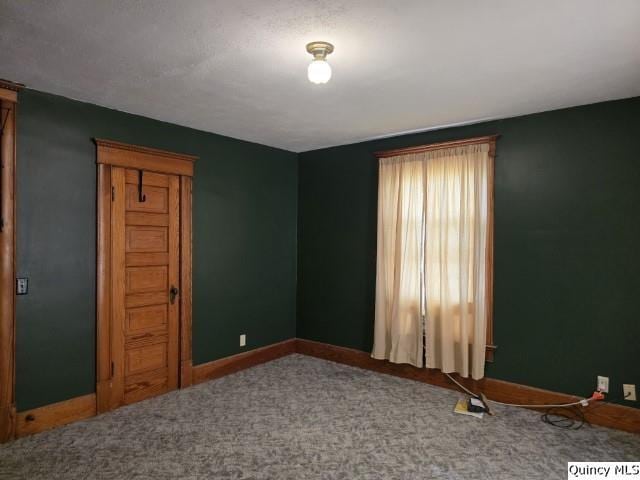 722 Wabash Ave, Carthage, IL 62321 - spare room featuring baseboards and carpet
