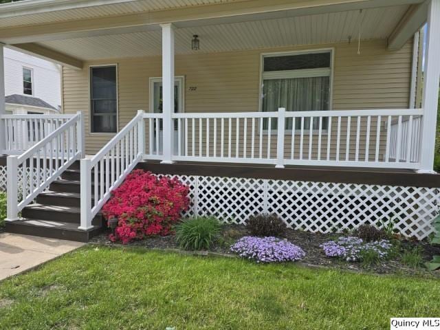 722 Wabash Ave, Carthage, IL 62321 - doorway to property featuring a porch and a lawn