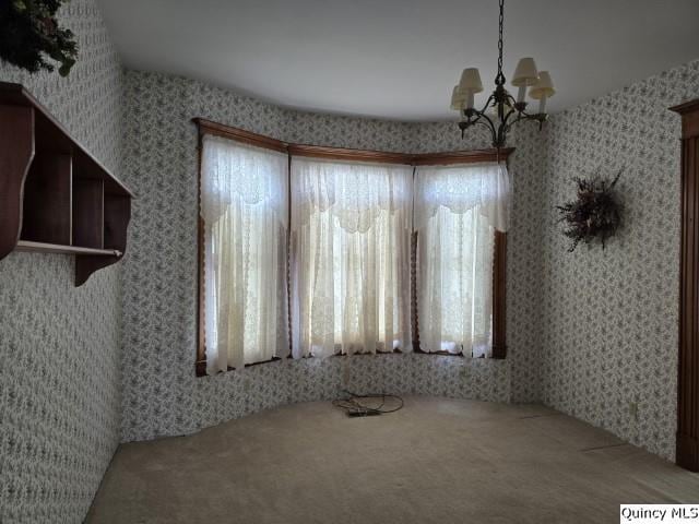 722 Wabash Ave, Carthage, IL 62321 - unfurnished dining area featuring carpet floors, a chandelier, plenty of natural light, and wallpapered walls