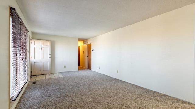 spare room with light colored carpet