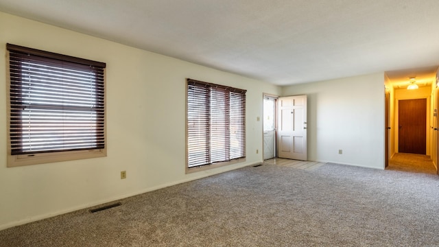 empty room with light colored carpet and baseboards