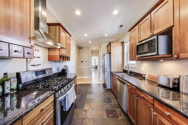 kitchen with stainless steel appliances, wall chimney exhaust hood, a sink, ornamental molding, and recessed lighting