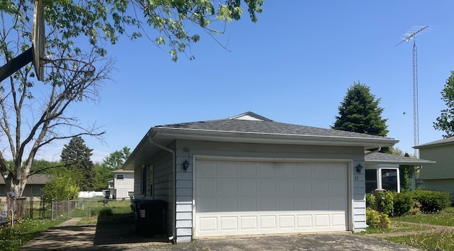 22 Emery Dr, Bourbonnais, IL 60914 - view of side of property with fence, driveway, and a shingled roof