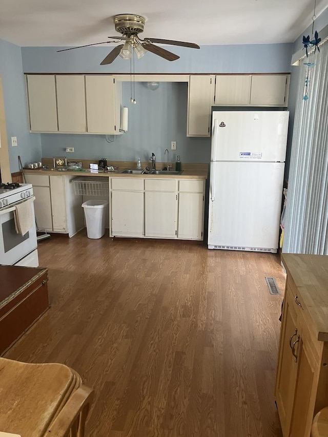 22 Emery Dr, Bourbonnais, IL 60914 - kitchen featuring white appliances, a ceiling fan, a sink, dark wood-style flooring, and white cabinetry