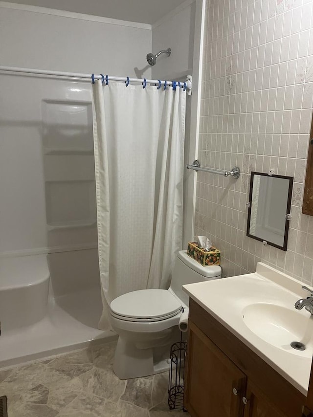22 Emery Dr, Bourbonnais, IL 60914 - full bathroom featuring tile walls, a stall shower, vanity, toilet, and decorative backsplash
