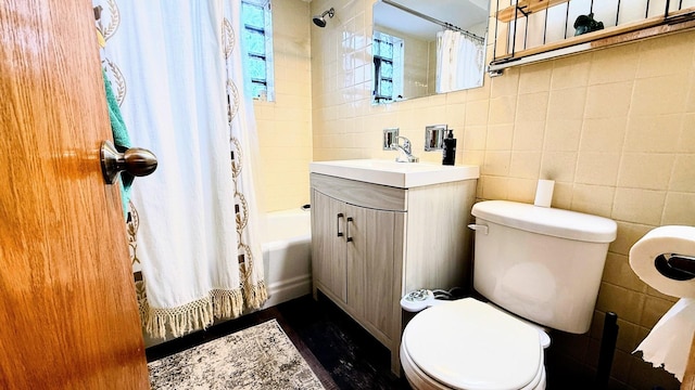 full bathroom featuring tile walls, toilet, shower / bath combination with curtain, wood finished floors, and vanity