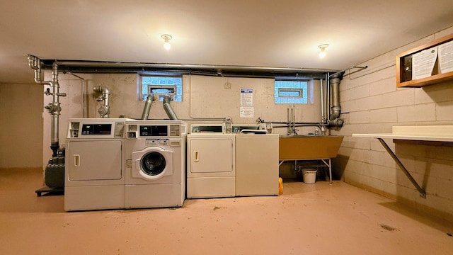 community laundry featuring independent washer and dryer and concrete block wall