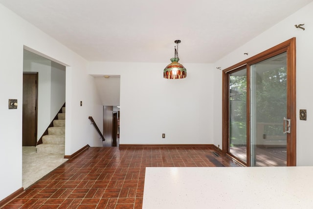 311 Hillside Ln, Bloomington, IL 61701 - unfurnished dining area featuring brick patterned floors, stairway, and baseboards