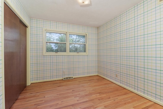 311 Hillside Ln, Bloomington, IL 61701 - spare room featuring light wood-style flooring and wallpapered walls
