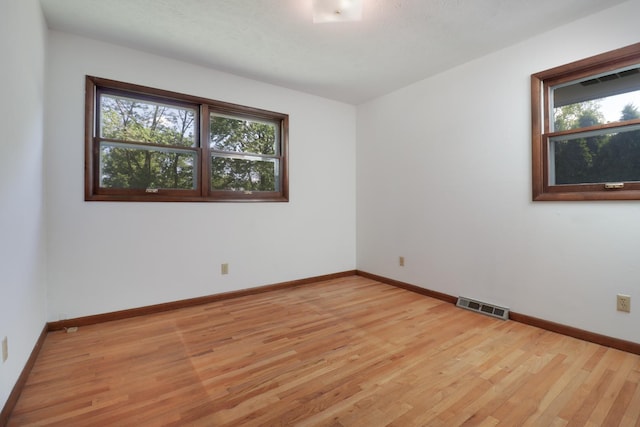 311 Hillside Ln, Bloomington, IL 61701 - unfurnished room with plenty of natural light, light wood finished floors, and baseboards