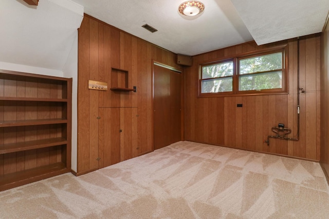 311 Hillside Ln, Bloomington, IL 61701 - unfurnished room featuring carpet and wood walls
