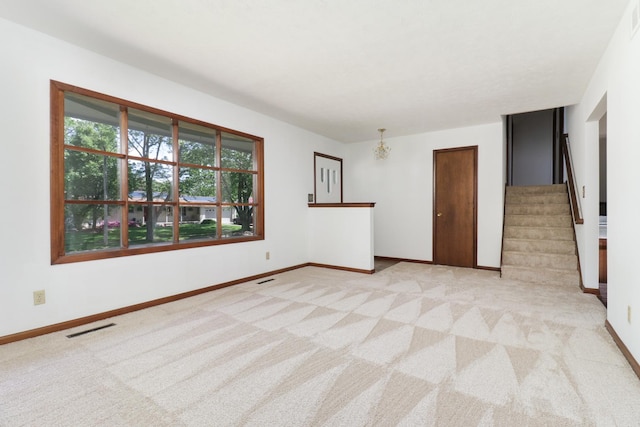311 Hillside Ln, Bloomington, IL 61701 - carpeted empty room featuring stairs and baseboards
