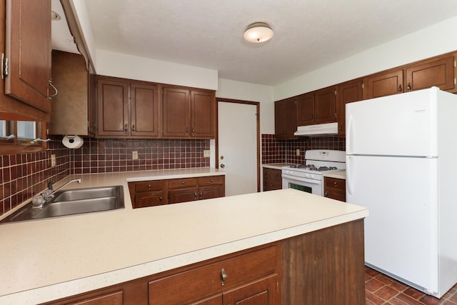 311 Hillside Ln, Bloomington, IL 61701 - kitchen featuring white appliances, under cabinet range hood, a sink, and light countertops
