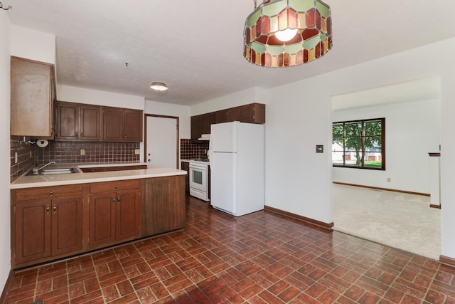 311 Hillside Ln, Bloomington, IL 61701 - kitchen with white appliances, baseboards, light countertops, a peninsula, and tasteful backsplash
