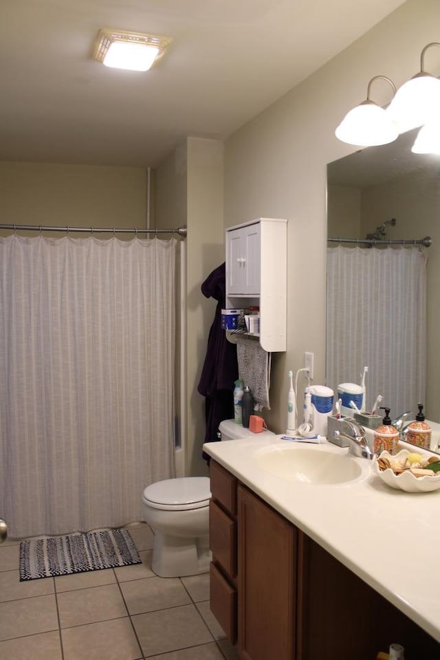 bathroom with tile patterned floors, vanity, toilet, and a shower with curtain