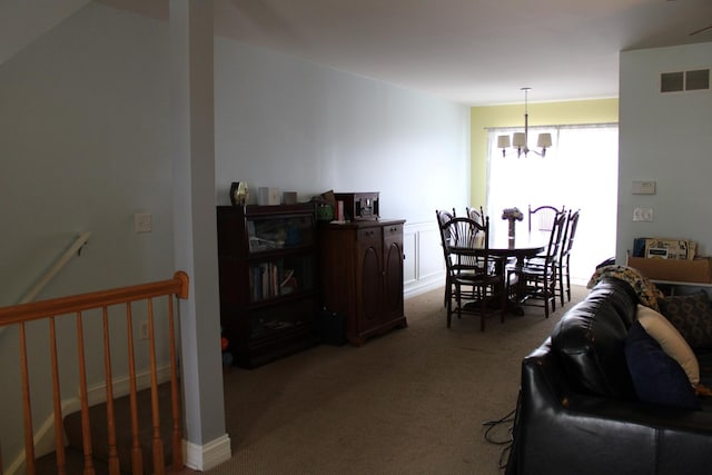dining space with a chandelier and light carpet