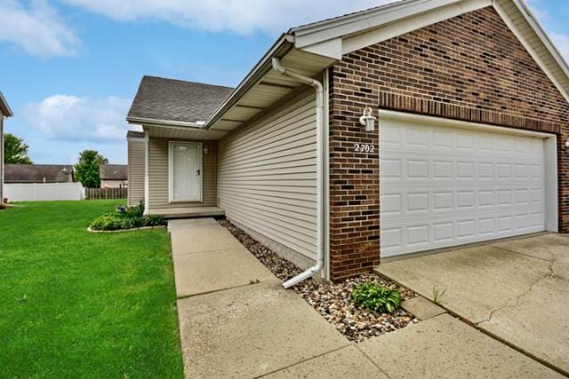 2702 Westbrook Dr, Bloomington, IL 61705 - property entrance featuring brick siding and an attached garage