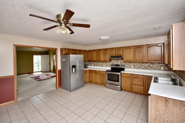 2702 Westbrook Dr, Bloomington, IL 61705 - kitchen featuring appliances with stainless steel finishes, a sink, under cabinet range hood, ceiling fan, and a textured ceiling