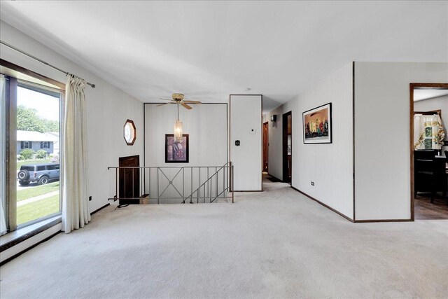 1264 N Kennedy Dr, Streamwood, IL 60107 - unfurnished living room featuring carpet flooring, a ceiling fan, and baseboards