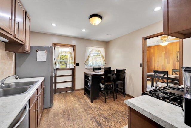 1264 N Kennedy Dr, Streamwood, IL 60107 - kitchen featuring light countertops, a sink, stainless steel appliances, wood finished floors, and recessed lighting