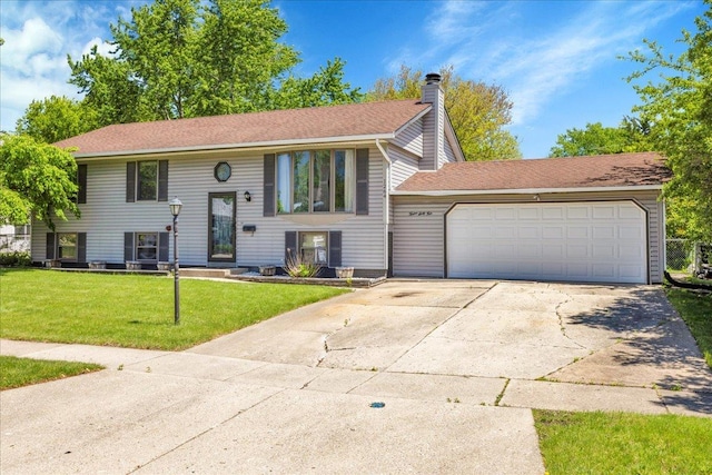 1264 N Kennedy Dr, Streamwood, IL 60107 - split foyer home featuring a chimney, a front lawn, concrete driveway, a garage, and a shingled roof