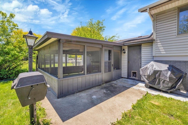 1264 N Kennedy Dr, Streamwood, IL 60107 - rear view of house featuring a sunroom and a patio area
