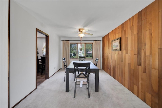 1264 N Kennedy Dr, Streamwood, IL 60107 - dining area with wood walls, ceiling fan, and light colored carpet