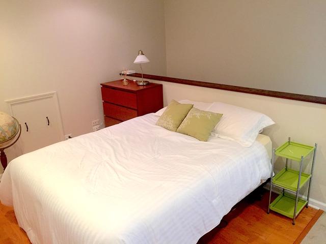 bedroom with baseboards and wood finished floors