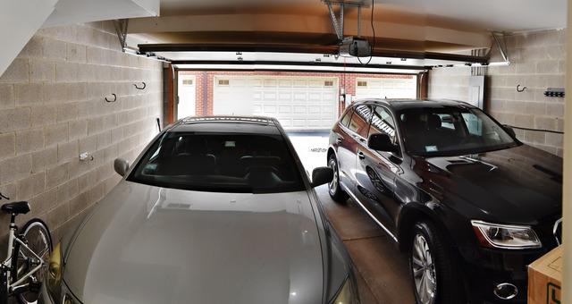 garage with concrete block wall and a garage door opener
