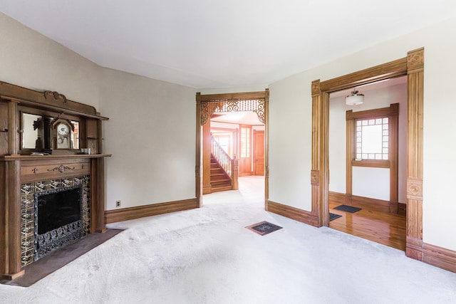 706 Washington Ave, Dixon, IL 61021 - unfurnished living room with carpet, plenty of natural light, a fireplace with flush hearth, and baseboards
