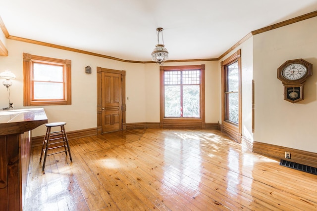 706 Washington Ave, Dixon, IL 61021 - unfurnished dining area with light wood-style flooring, baseboards, and ornamental molding