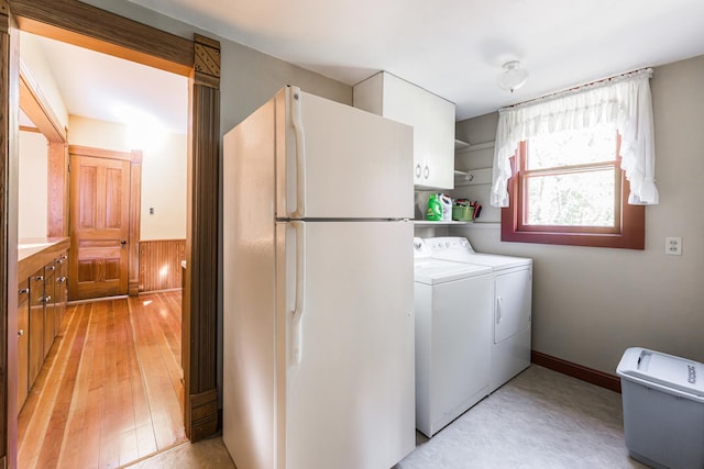706 Washington Ave, Dixon, IL 61021 - laundry room featuring separate washer and dryer, cabinet space, and light wood finished floors