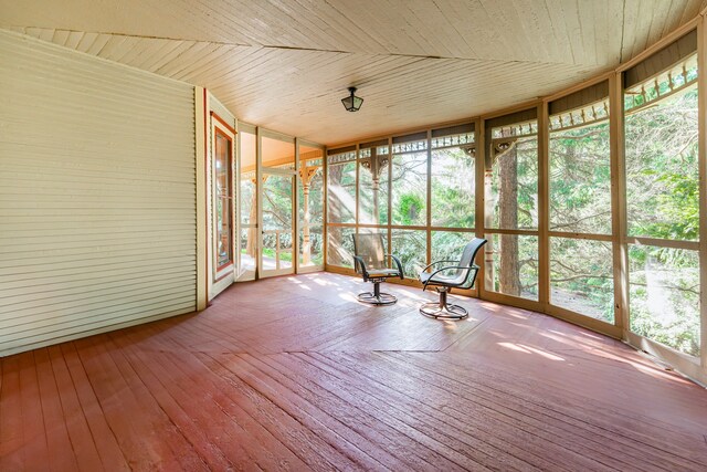 706 Washington Ave, Dixon, IL 61021 - unfurnished sunroom featuring a wall of windows, wood ceiling, a wooden deck, and hardwood / wood-style floors