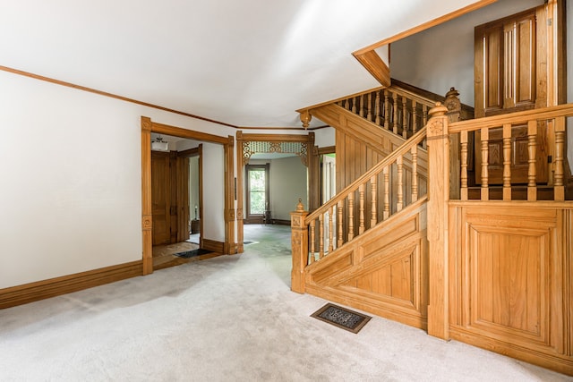 706 Washington Ave, Dixon, IL 61021 - staircase featuring baseboards, crown molding, and carpet