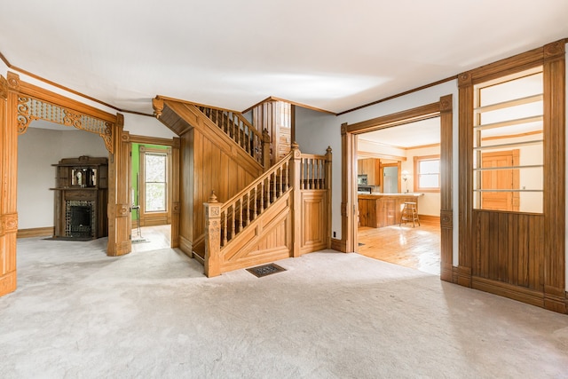 706 Washington Ave, Dixon, IL 61021 - staircase with crown molding, plenty of natural light, carpet flooring, and baseboards